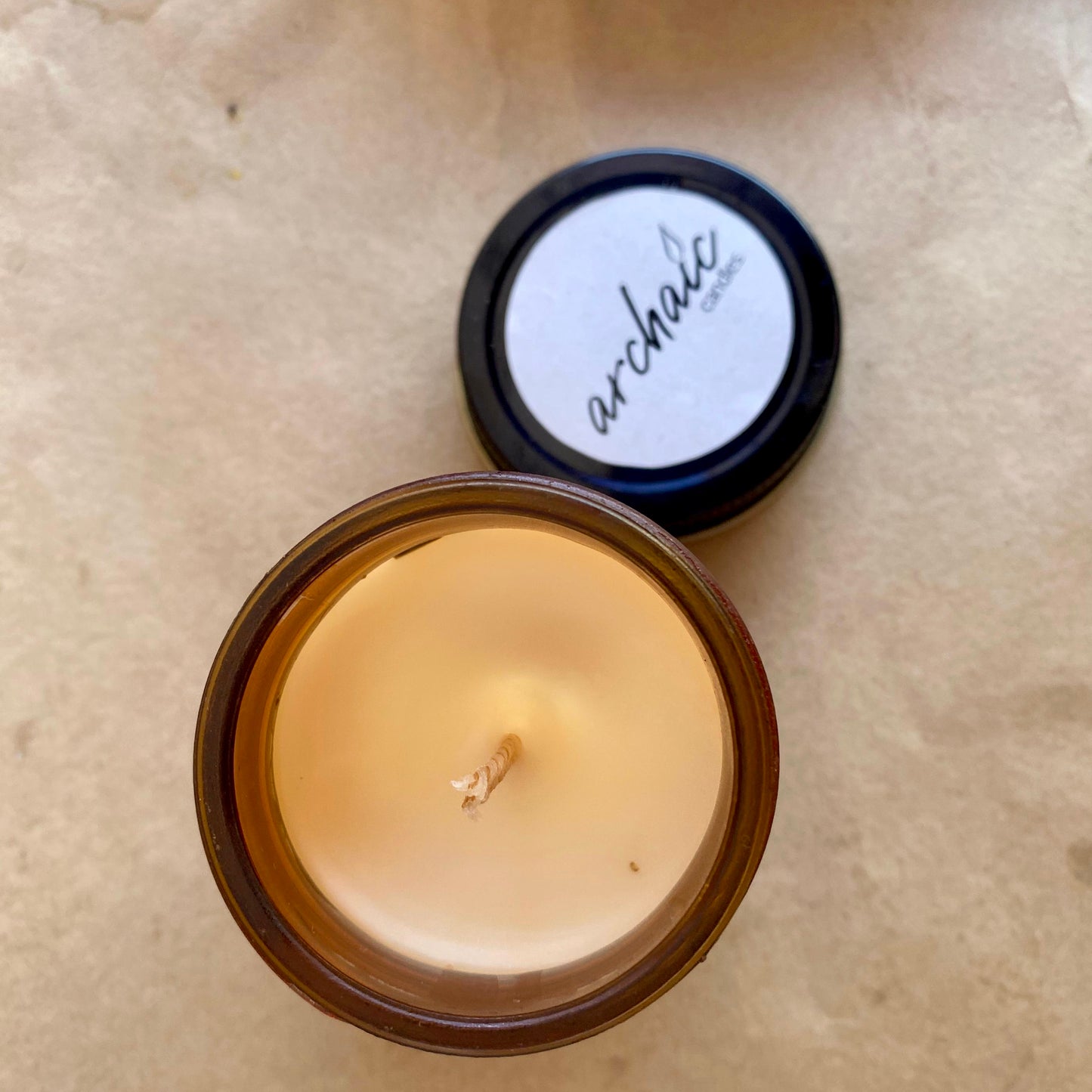 Top view of Twisted Red cranberry apple soy candle in amber glass, 100 gm, smooth 24-hour burn surface