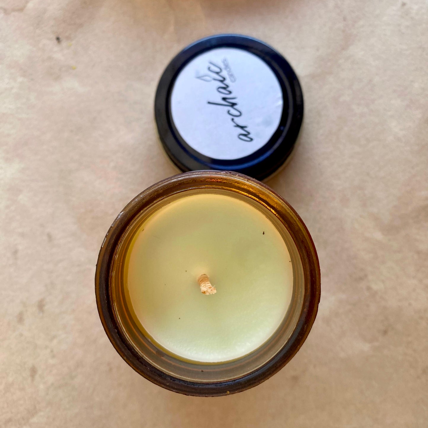 Top view of Citrus Ember lemongrass soy candle in amber glass, 100 gm, smooth surface for 24-hour burn