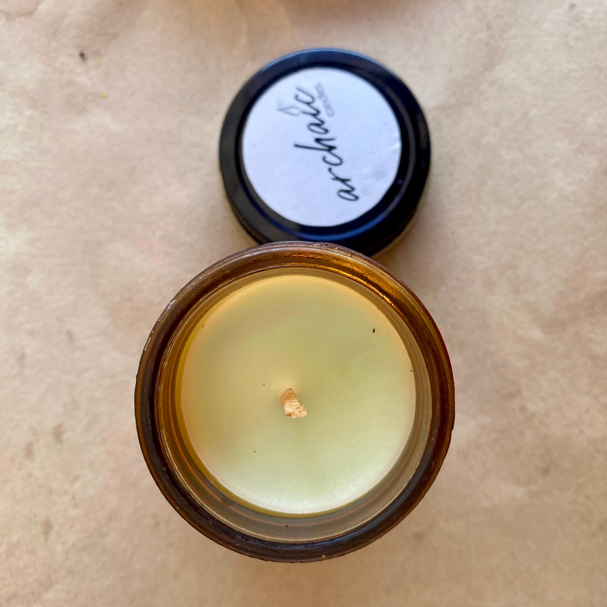 Top view of Citrus Ember lemongrass soy candle in amber glass, 100 gm, smooth surface for 24-hour burn