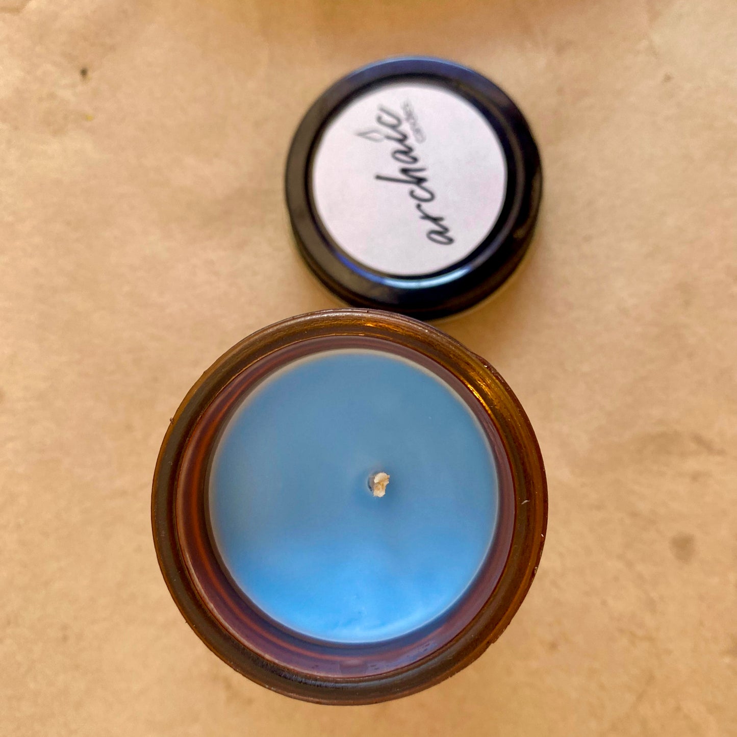 Top view of Misty Wave ocean breeze soy candle in amber glass, 100 gm, smooth surface for 24-hour burn